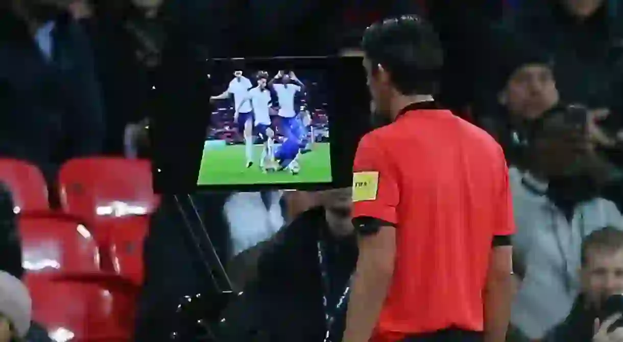 Referee Deniz Aytekin consults VAR before awarding a penalty to Italy