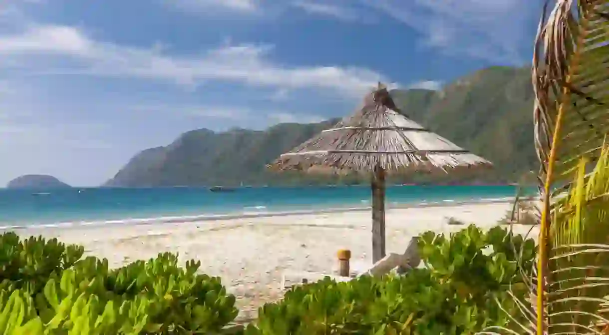 Straw umbrella on a tropical beach on a Con Dao island, Vietnam