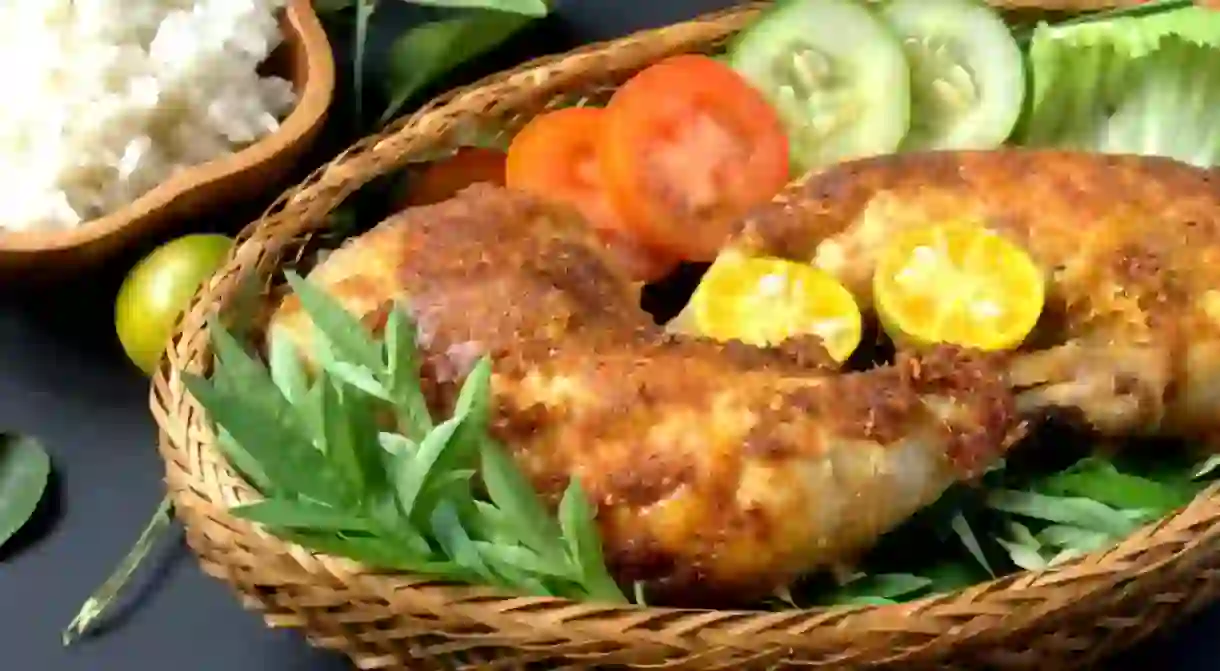 Fried chicken served with rice and vegetables