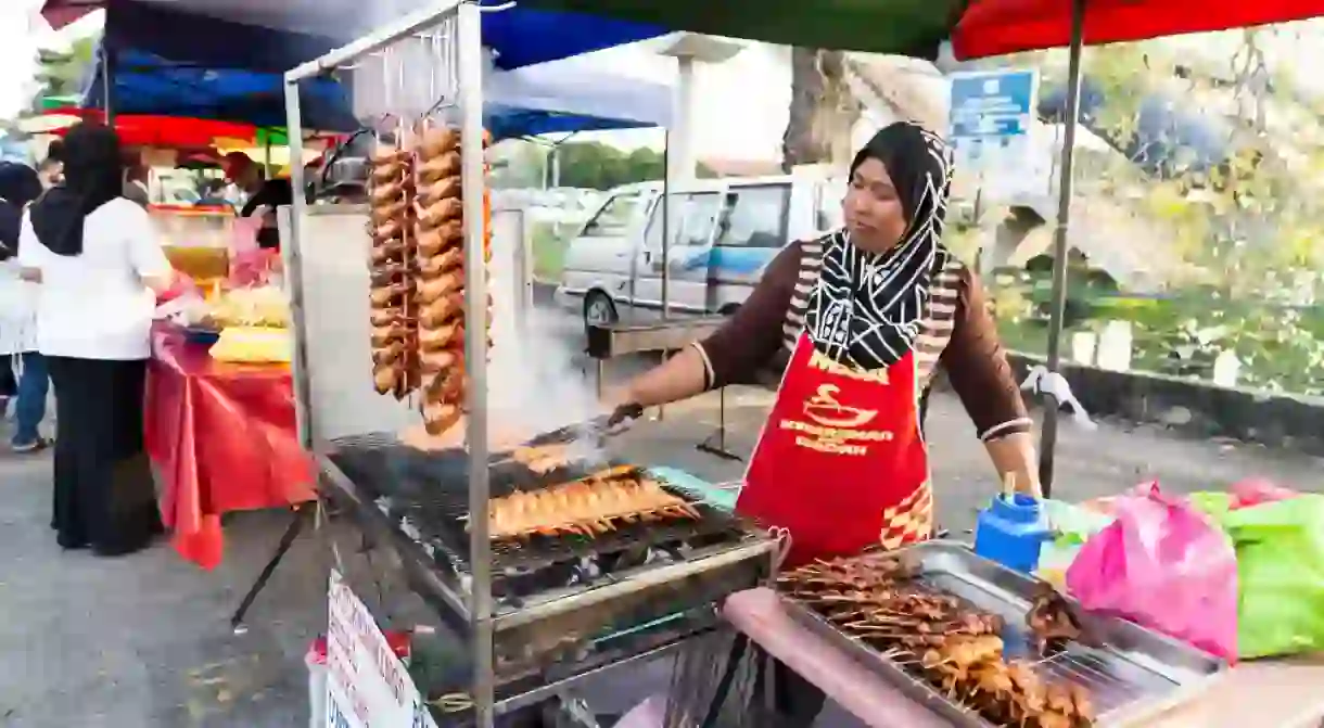 Vendor selling cuisine at street bazaar, Kuala Lumpur, Malaysia