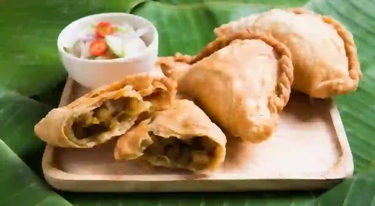 Curry Puff Stuffed Chicken on Banana Leaf Background