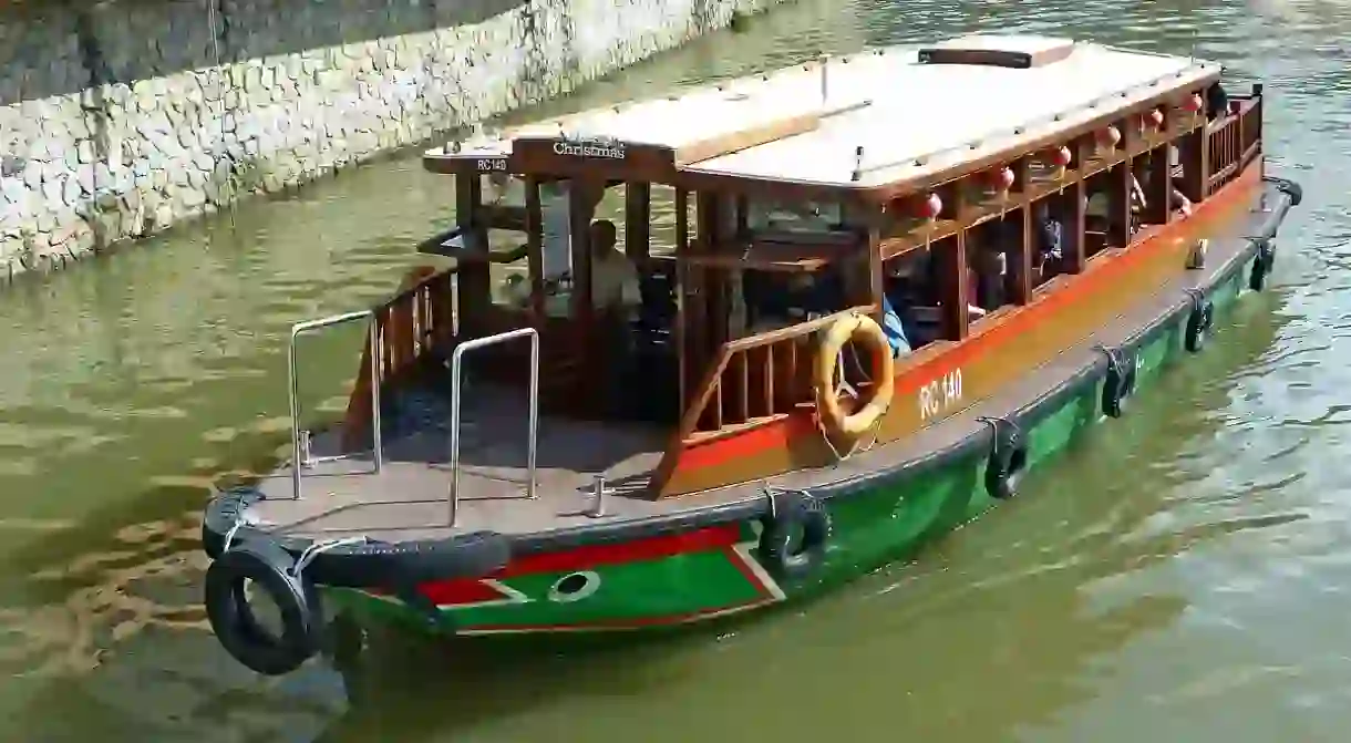 A bumboat takes a trip down Singapore River