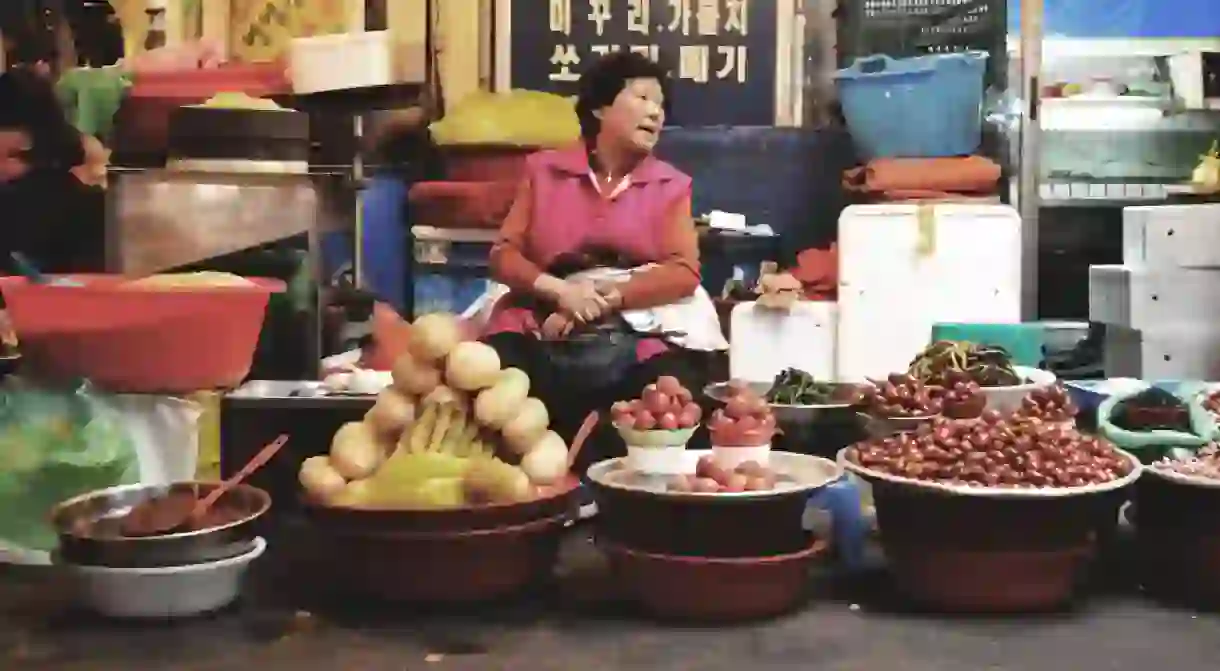 A Korean ajumma selling her wares in a traditional South Korean market