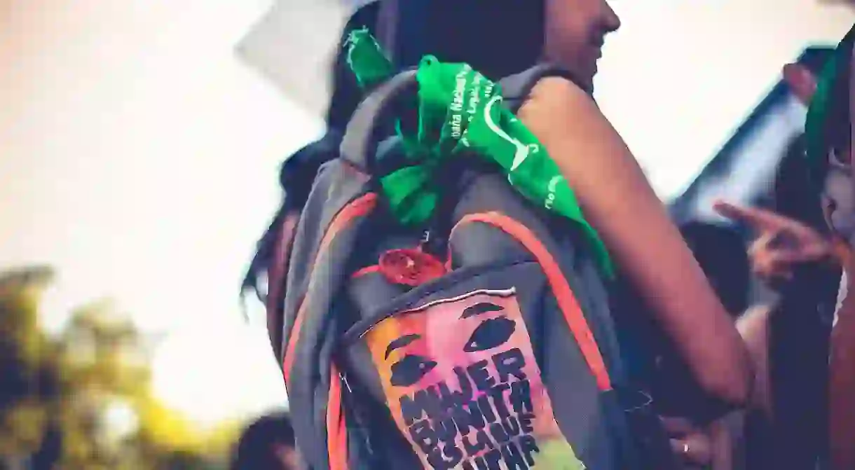 Tied to backpacks or worn around necks and wrists, the green handkerchief is a symbol of pride for millennial activists