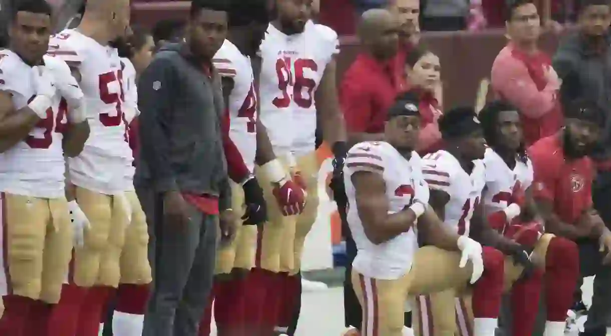 San Franciso 49ers players kneel during the national anthem