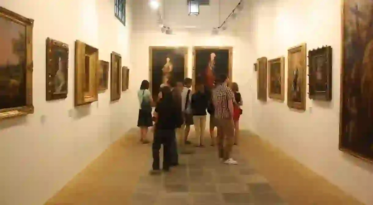 Visitors admire paintings at the Bodegas Tradición in Jerez de la Frontera, Spain