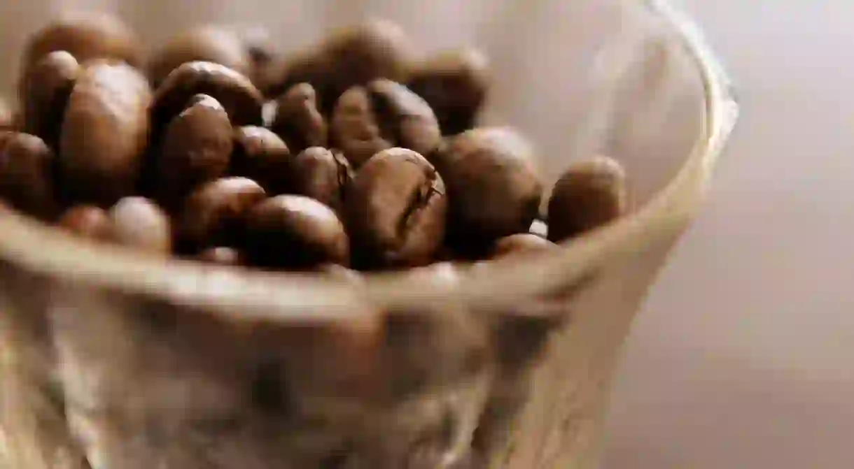 A cup of coffee beans wait to become a drink