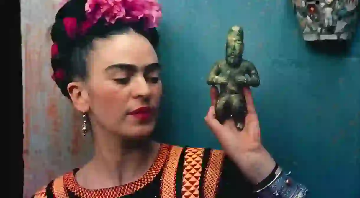 Frida Kahlo with Olmec figurine, 1939