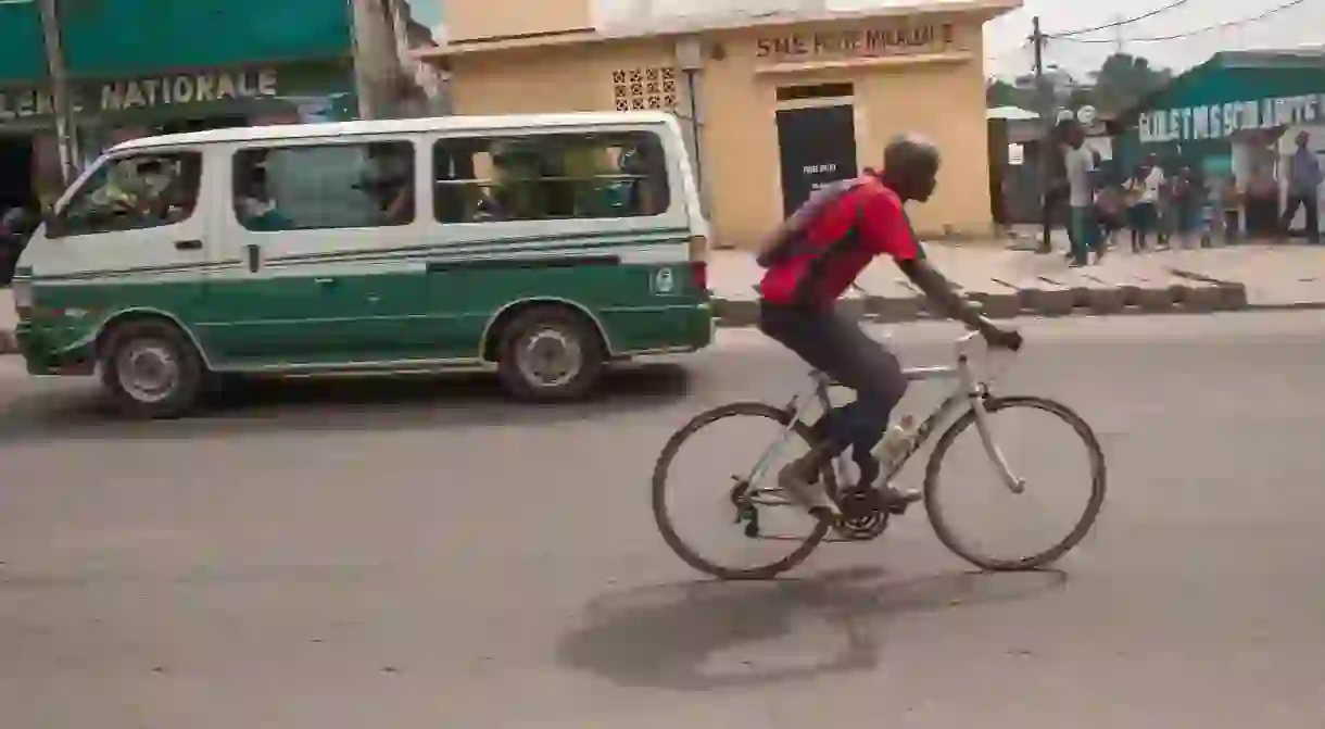 A man cycles through the streets of Brazzaville