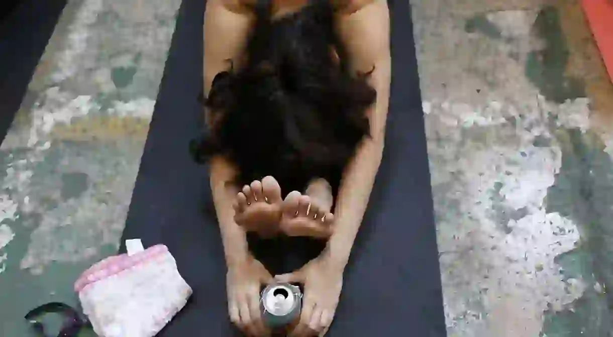 A yoga enthusiast attends a Beer Yoga class in Bangkok, Thailand