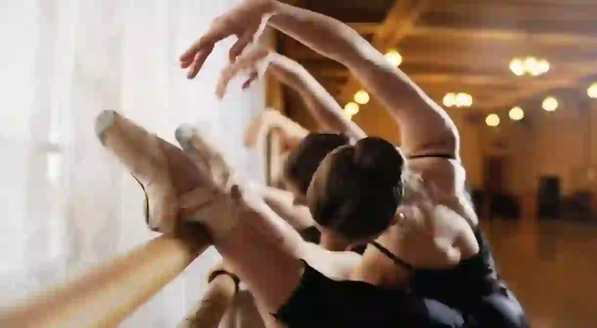 Ballerinas practicing barre exercises