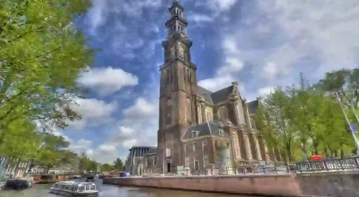 The Westerkerk Church and a tour boat in Amsterdam