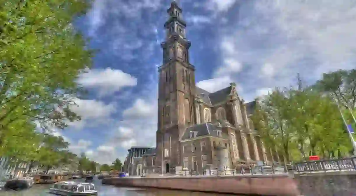 The Westerkerk Church and a tour boat in Amsterdam