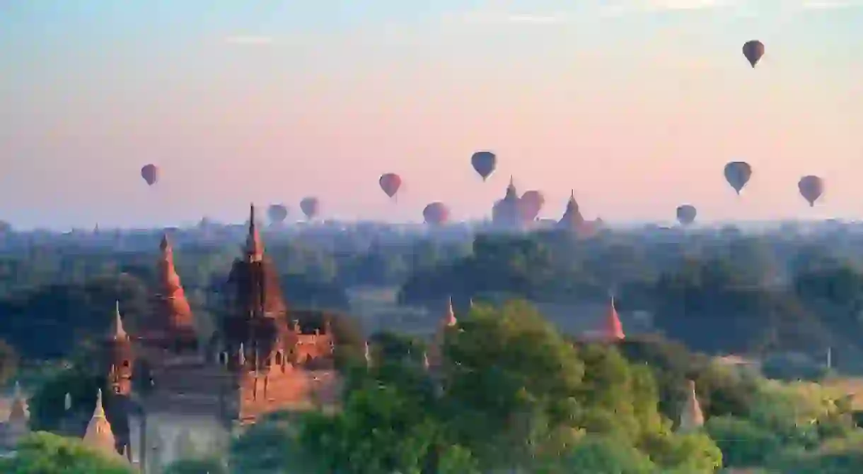 Hot air balloons over pagodas in sunrise at Bagan, Myanmar