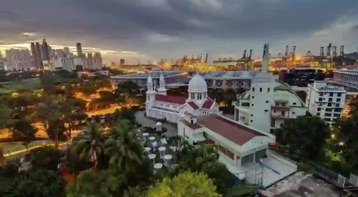 An aerial view of the Romano-Byzantine-inspired Church of St Teresa, against the backdrop of contemporary Singapore