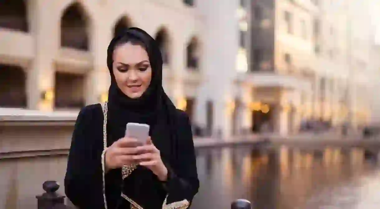 Muslim woman using mobile phone