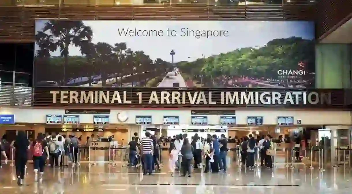 Travellers waiting in queue at arrival immigration of Changi International Airport in Singapore