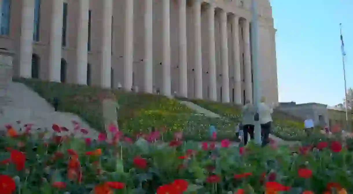 The steps of the Finnish Parliament House decorated with flowers.