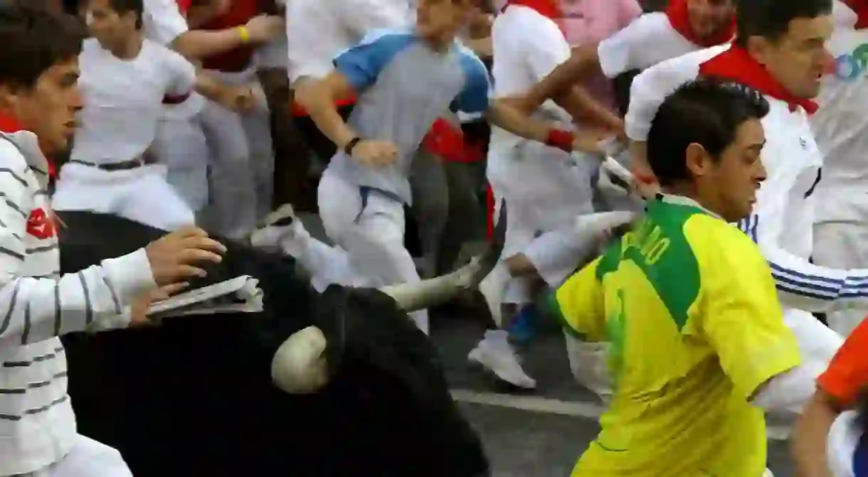 People taking part in an encierro, or bull run, in Pamplona