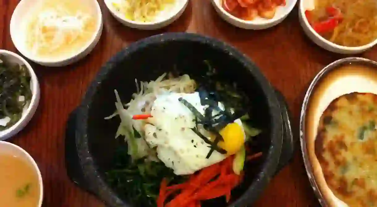 Dolsot (stone pot) bibimbap and assorted vegetable side dishes