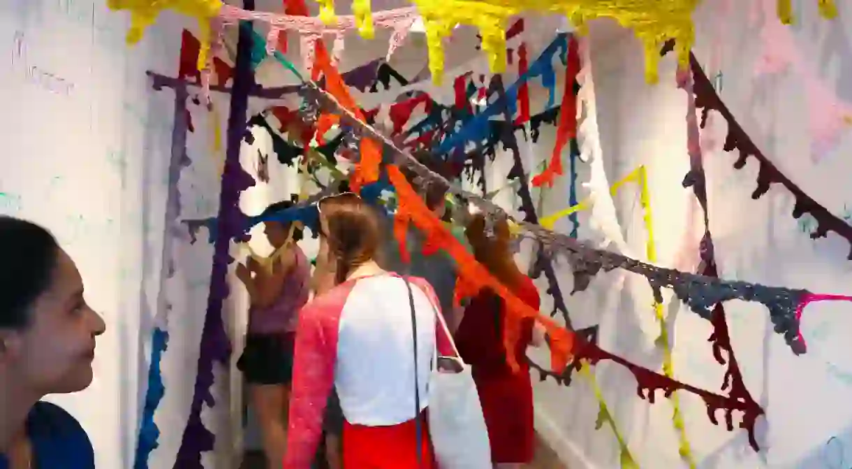 Truxton Circle, D.C. visitors explore In a Word, Amy Wikes knitted installation inside CulturalDCs Mobile Art Gallery