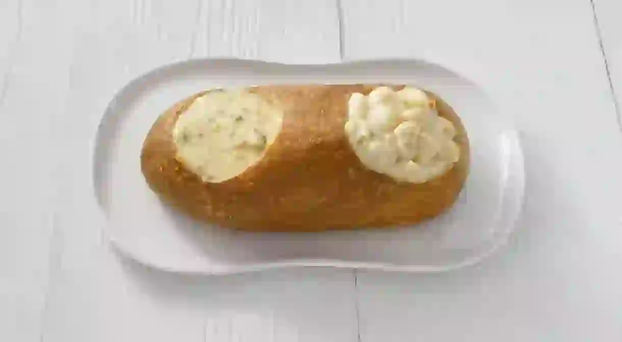 A double bread bowl filled with soup and mac and cheese