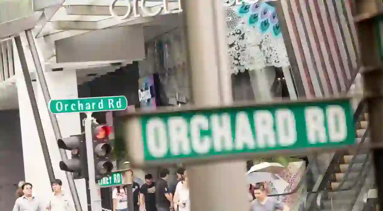 Pedestrians and shoppers cross Orchard Road in Singapore