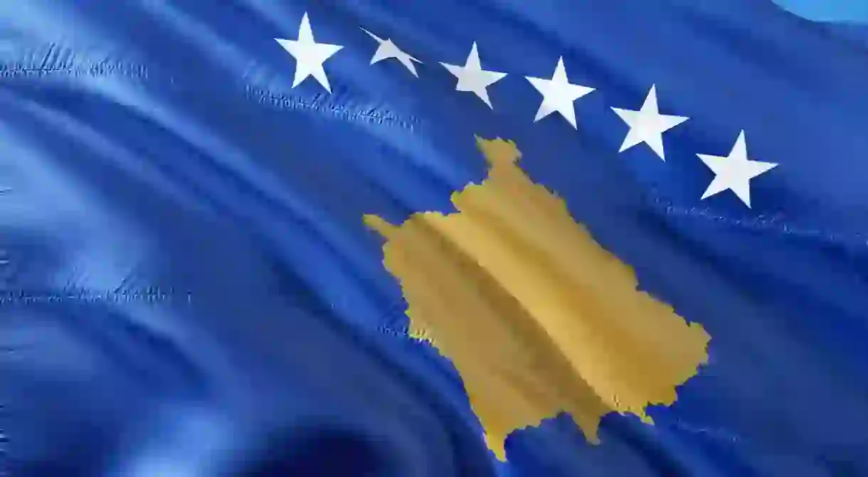 The national flag of Kosovo with the six stars that represent the countrys six ethnic groups