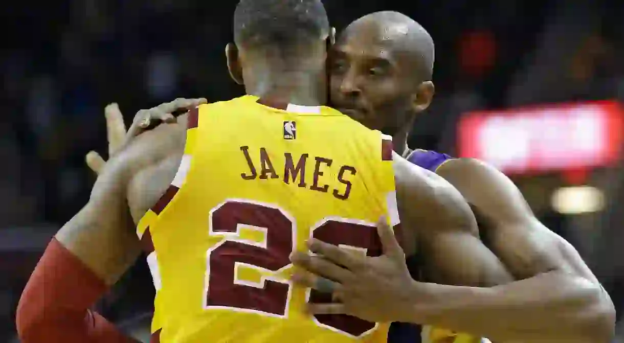 Los Angeles Lakers Kobe Bryant, back, hugs Cleveland Cavaliers LeBron James as Bryant leaves the game in the second half of an NBA basketball game, in Cleveland