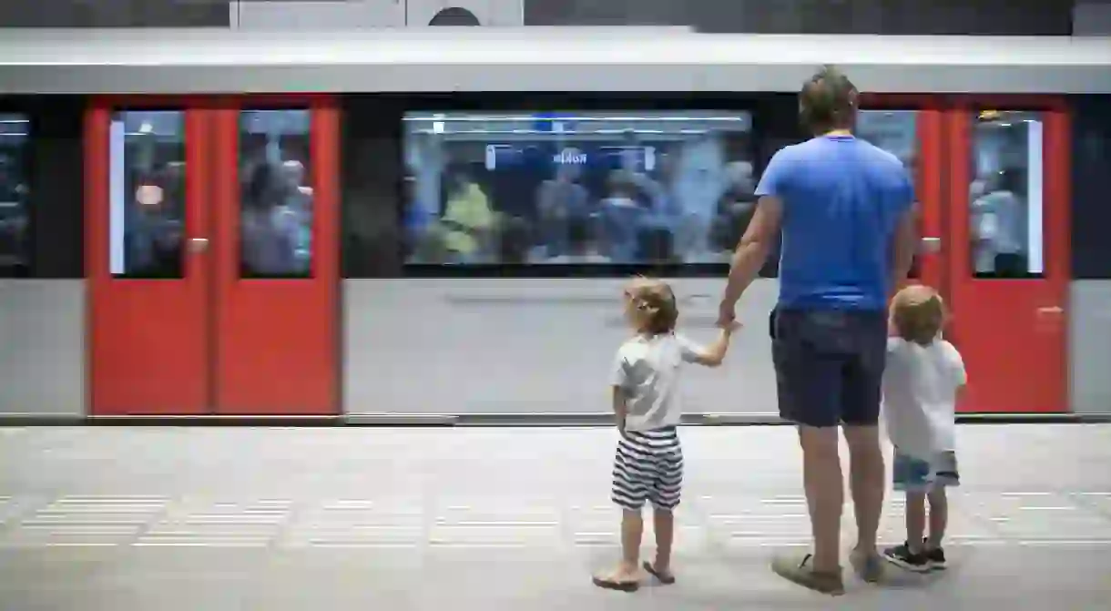 A man and two children wait for the metro, Amsterdam, the Netherlands