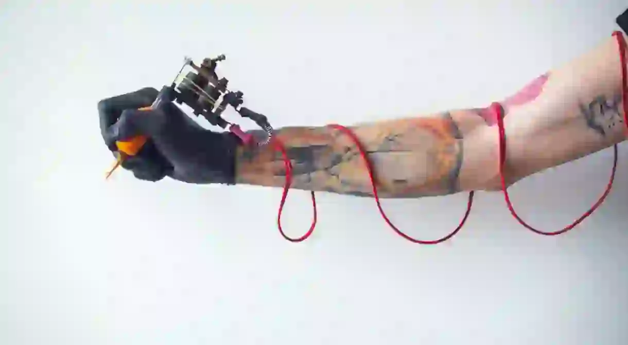 Tattoo artist holding tattoo machine