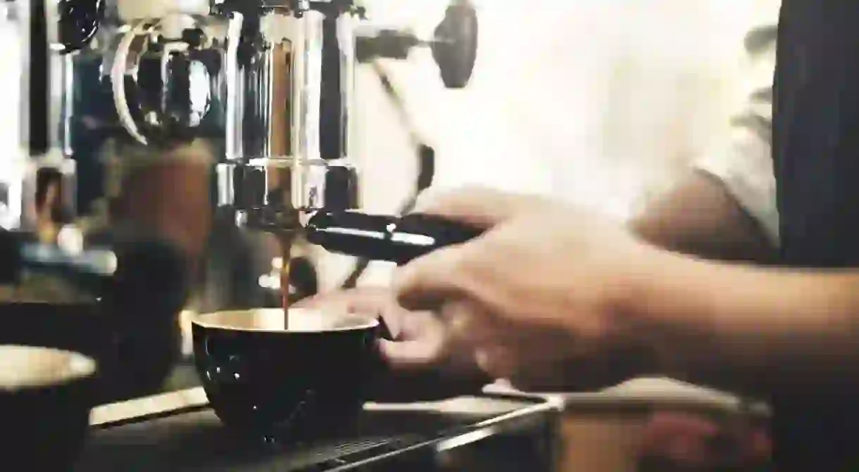 Barista making coffee in cafe