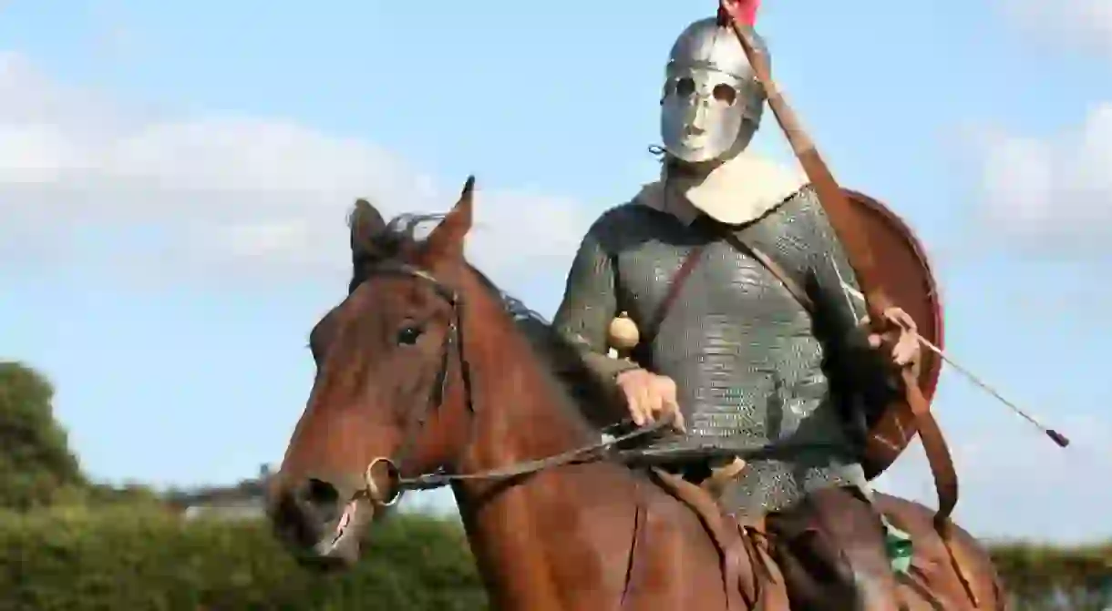 A historical reenactor on horseback