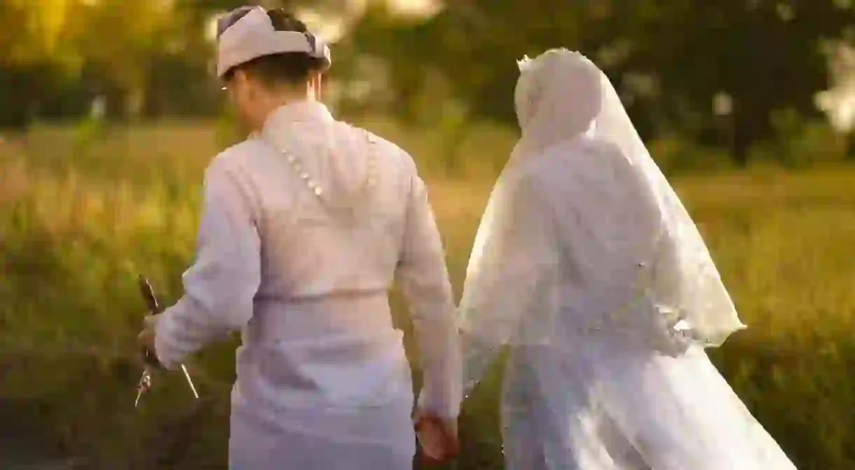 A Malay couple holding hands