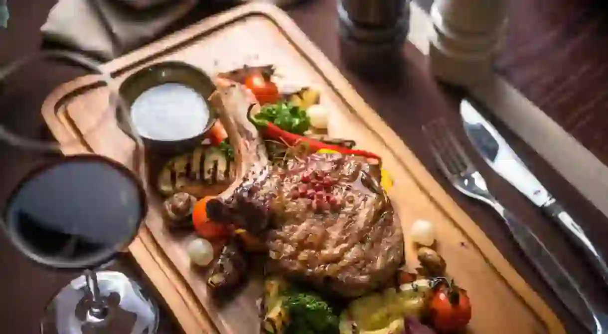 Veal Tomahawk steak with onion marmalade, boletus sauce and grilled vegetables