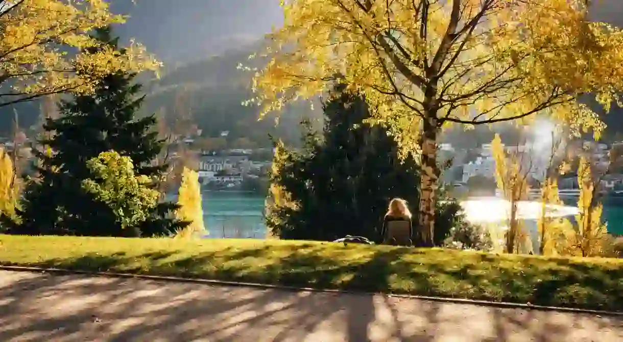 A person relaxes at Queenstown Gardens