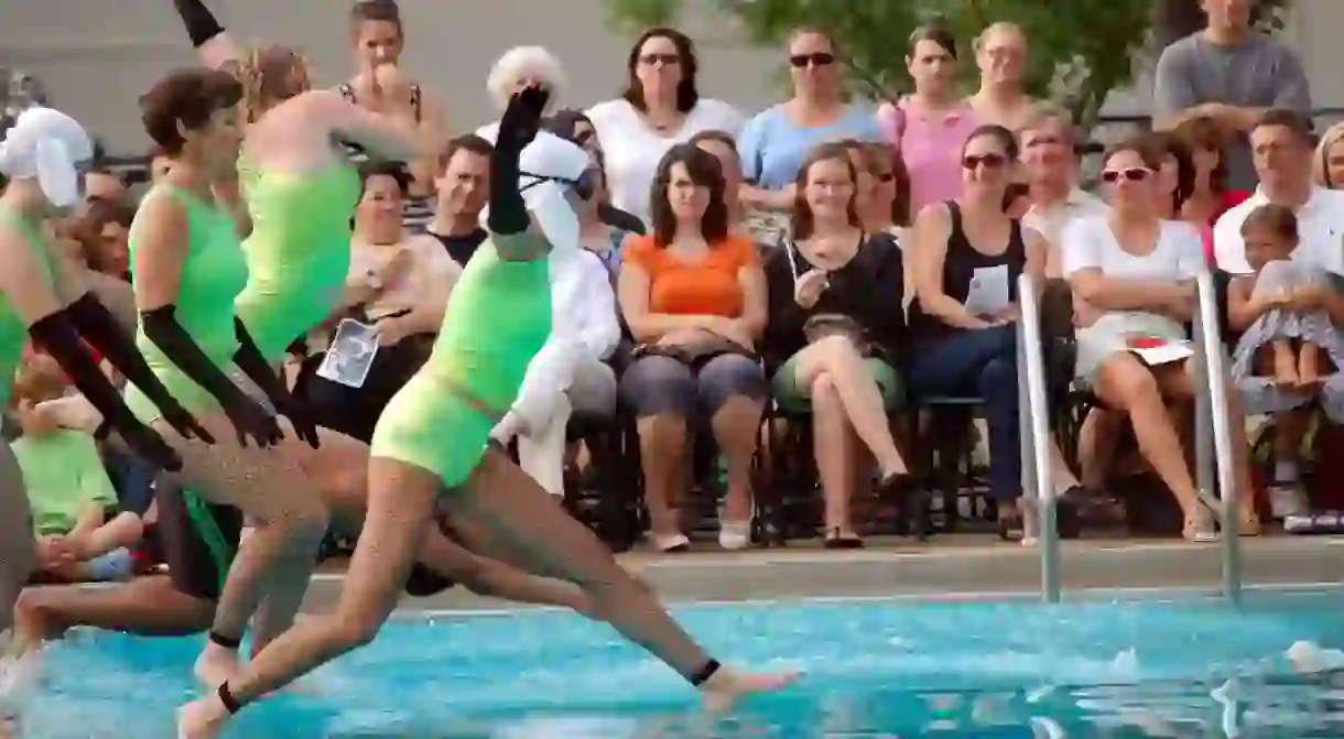 Fluid Movements synchronized swimmers jump in for their routine.