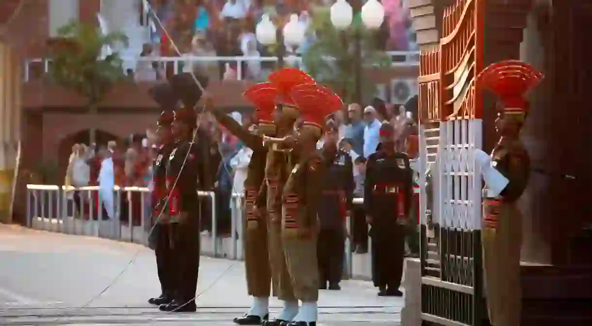 Indian Border Security Force soldiers and their Pakistani counterparts on parade before the start of a changing of guard ceremony at the Wagah-Attari border between India and Pakistan