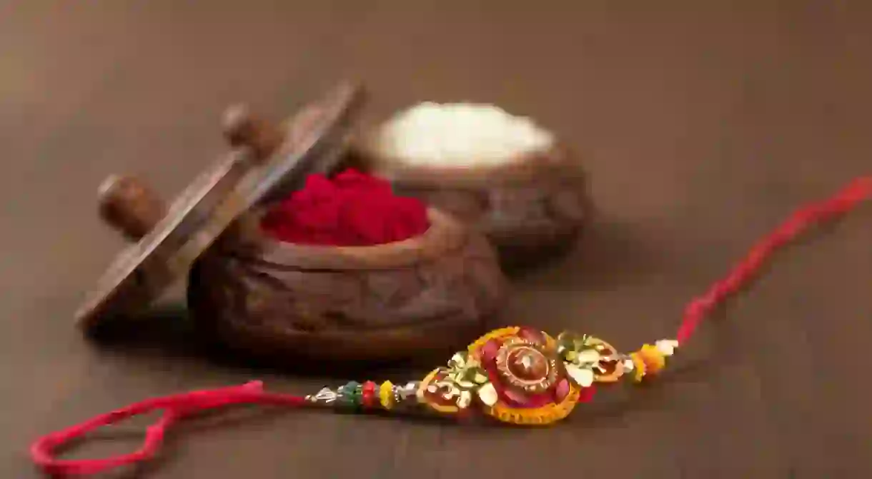 Sisters tie the rakhi on their brothers wrists as a symbol of love