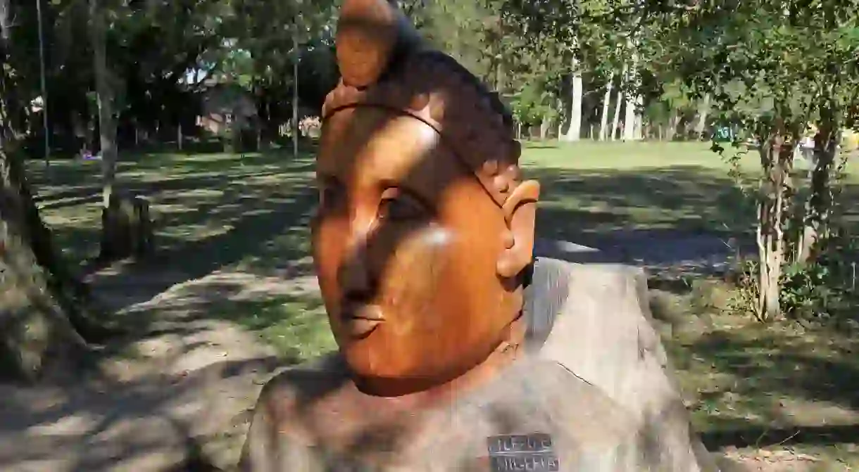 A giant wooden head sculpture greets visitors to Ile-Ife, Nigeria