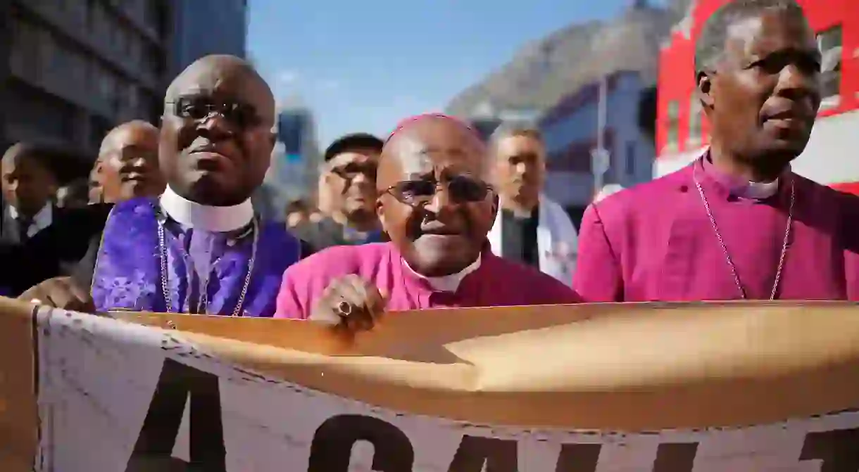 Archbishop Desmond Tutu marches during a rally