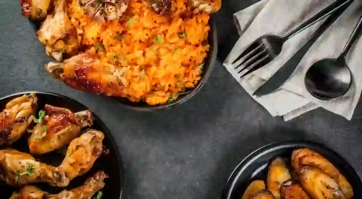 Nigerian jollof rice goes perfectly with grilled chicken wings and fried plantains.