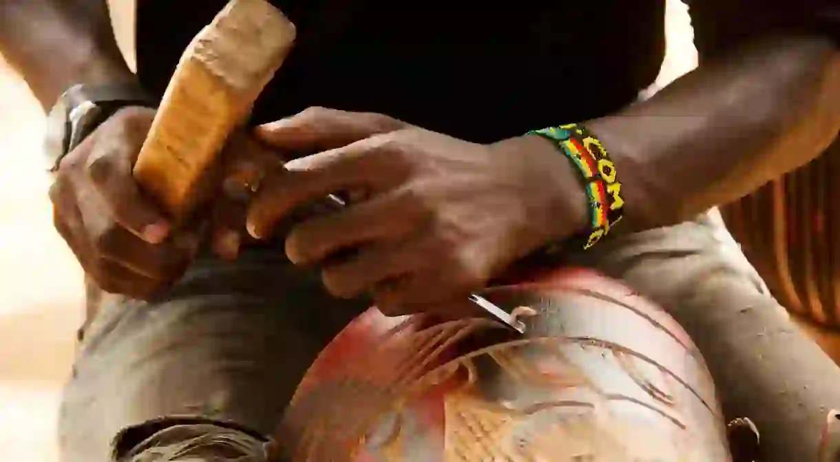 Carving djembe drum