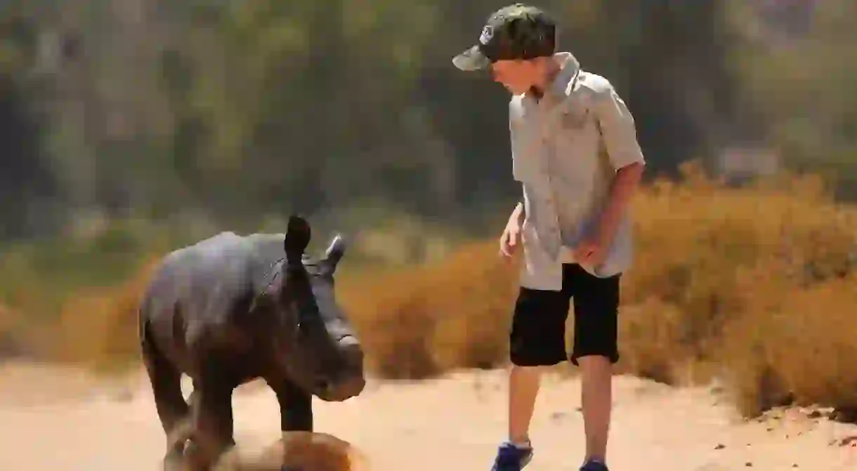 Hunter Mitchell with a baby rhino