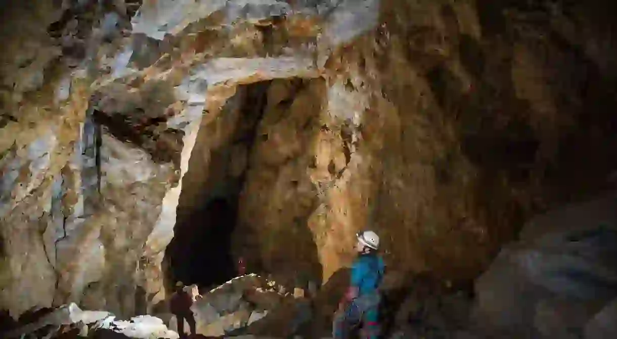 An exploration team enters a tunnel in Cueva de la Peña Negra, northeastern Oaxaca, Mexico