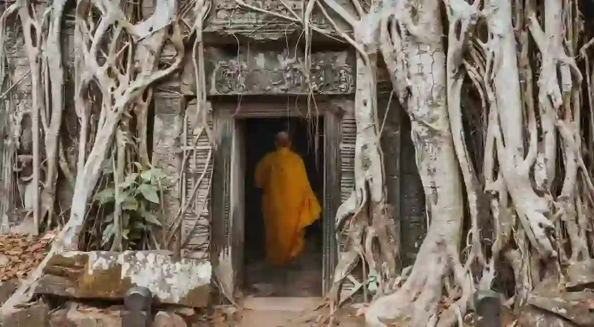 Monk in temple Ta Prom Angkor wat Cambodia landmark.