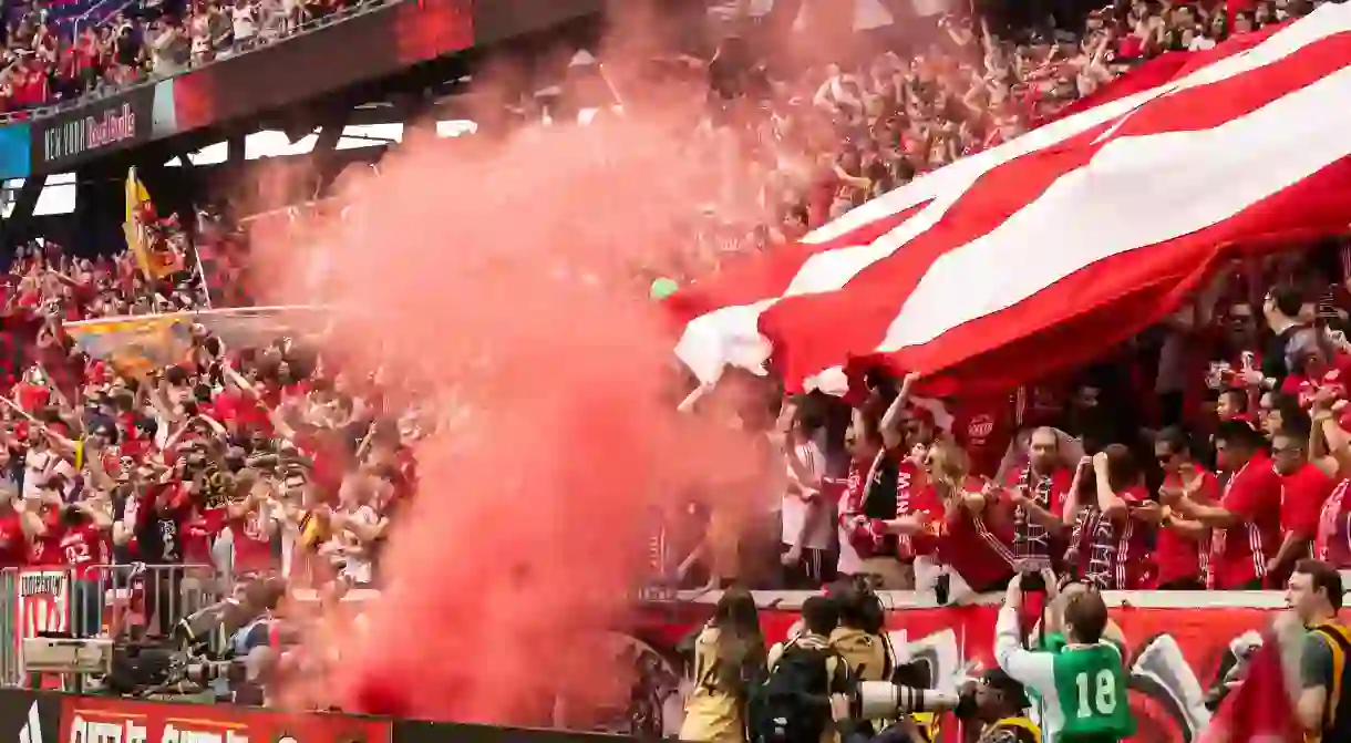 New York Red Bulls soccer fans celebrate during a game at Red Bull Arena