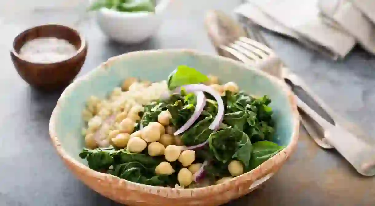 A warm salad with kale, chickpeas and quinoa is a healthy food option