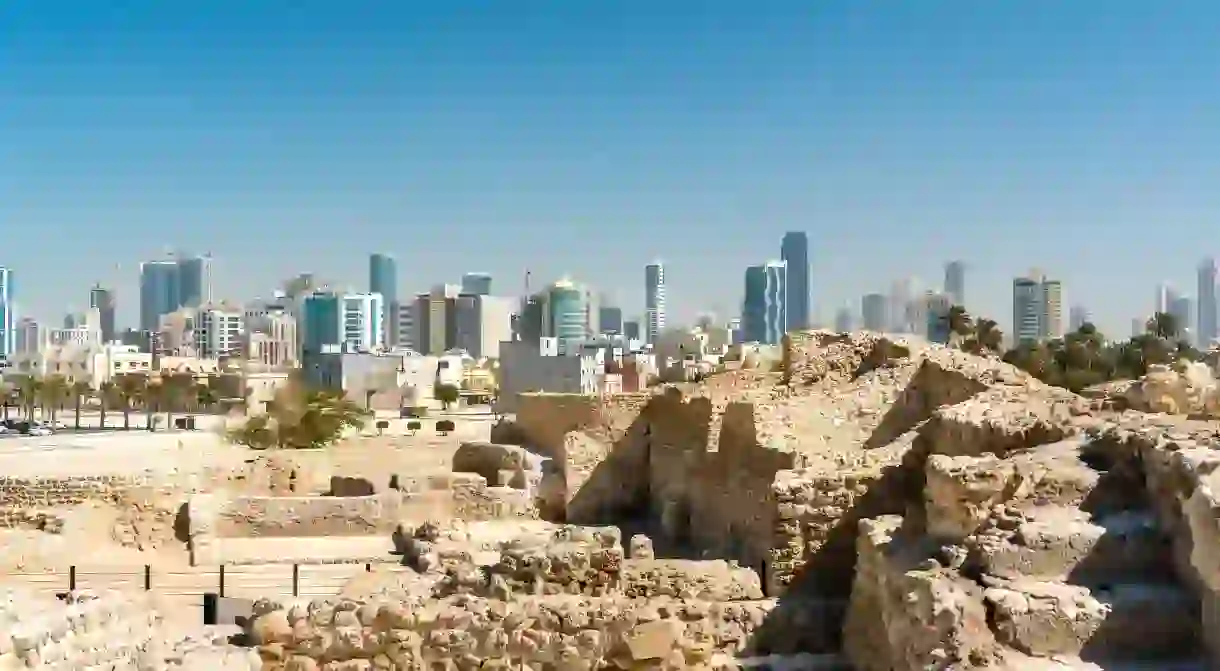 Ruins of Bahrain Fort with skyline of Manama