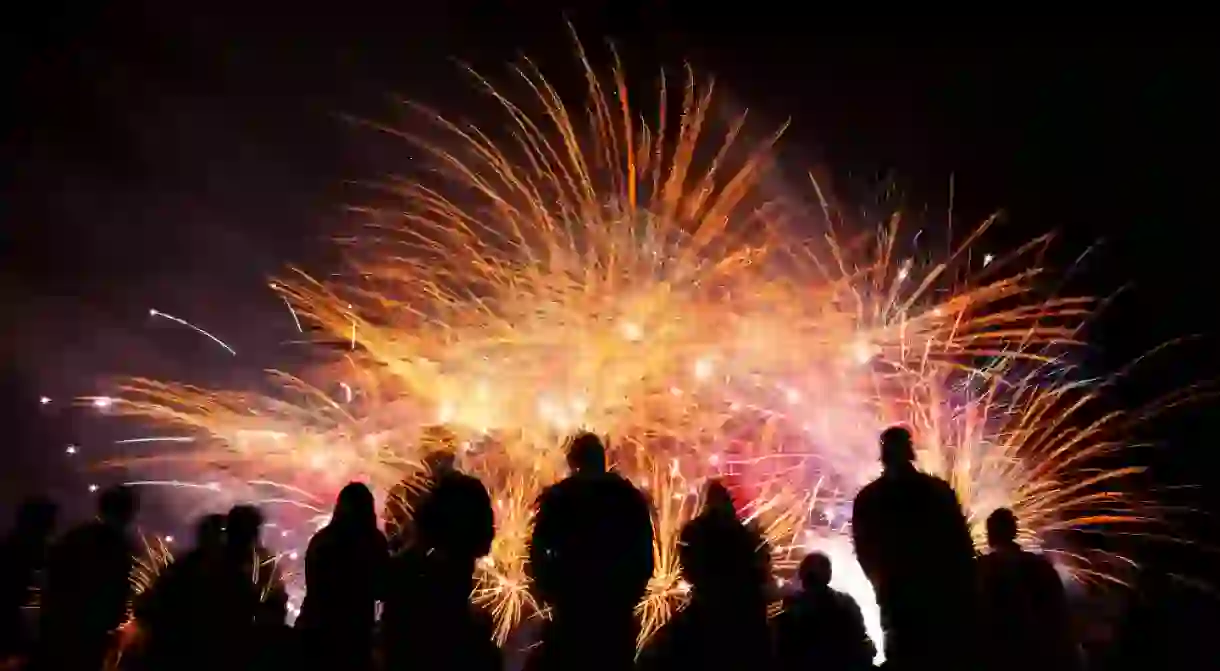 Group of people watching firework display